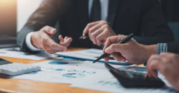 business people doing calculations analyze the work at the meeting
